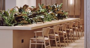 A bank of coworking desks with high stools at Summit House in Holborn